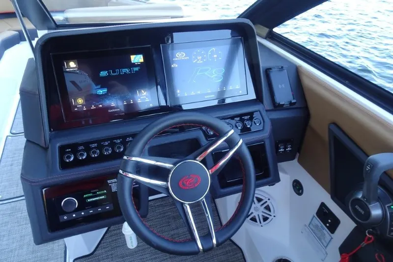 Slide: The Image of 2026 Cobalt R8 Surf boat dashboard with advanced touchscreen controls and steering wheel. - 19