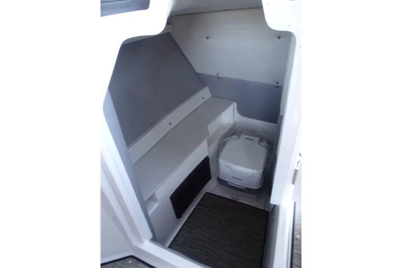 Slide: The Image of 2026 Cobalt R8 Surf boat interior with compact toilet and seating area. - 22