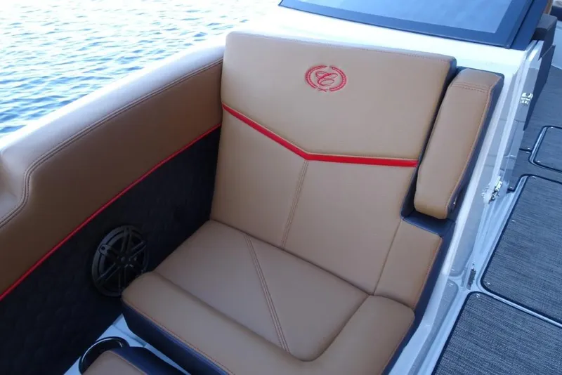 Slide: The Image of Luxurious seating on 2026 Cobalt R8 Surf boat with tan upholstery and red accents. - 25