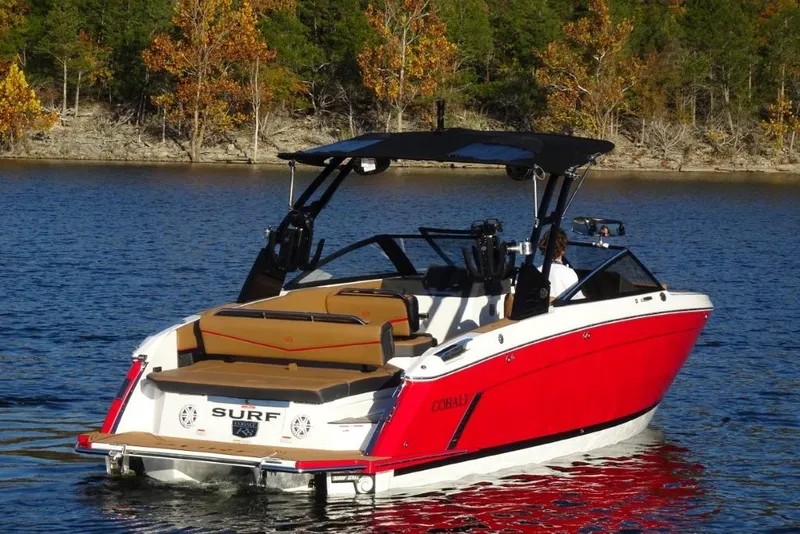 Slide: The Image of 2026 Cobalt R8 Surf boat on a lake with autumn trees in the background. - 4