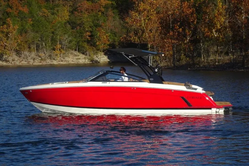 Slide: The Image of 2026 Cobalt R8 Surf boat on a lake with autumn trees in the background. - 7