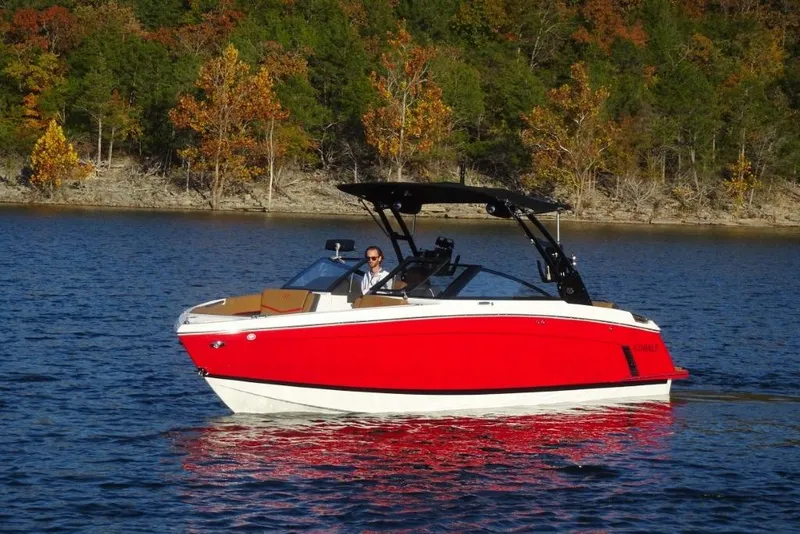 Slide: The Image of 2026 Cobalt R8 Surf boat on a lake with autumn trees in the background. - 9
