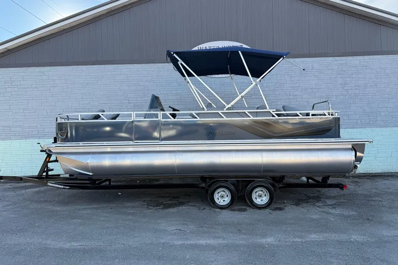 The Image of 2026 Avalon Venture 85 Center Fish 2385 pontoon boat on trailer, parked outdoors. - 1