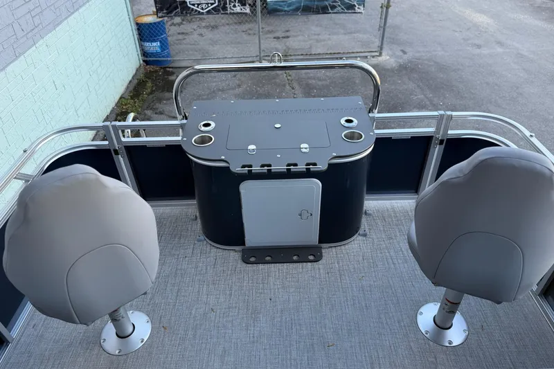 Slide: The Image of 2026 Avalon Venture 85 Center Fish 2385 boat interior with two seats and a central console. - 6