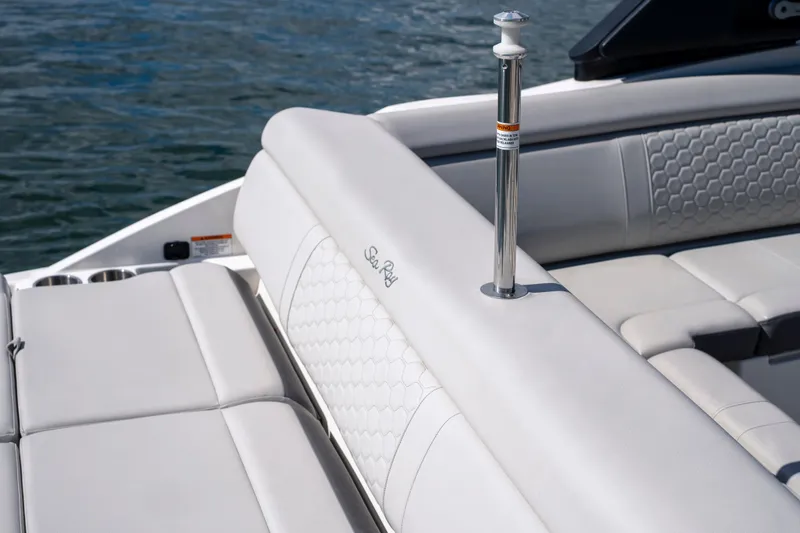 Slide: The Image of 2021 Yamaha Boats AR250 interior with white seating and water backdrop. - 11