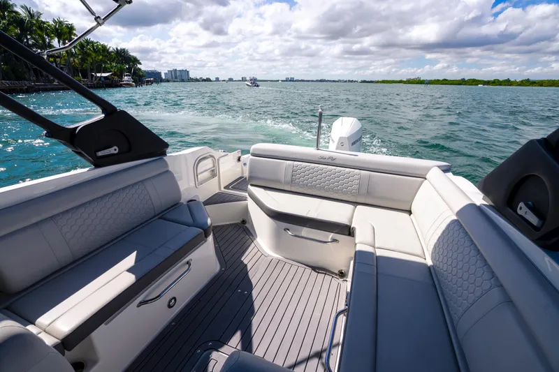 Slide: The Image of 2021 Yamaha Boats AR250 interior with luxurious seating on open water. - 16