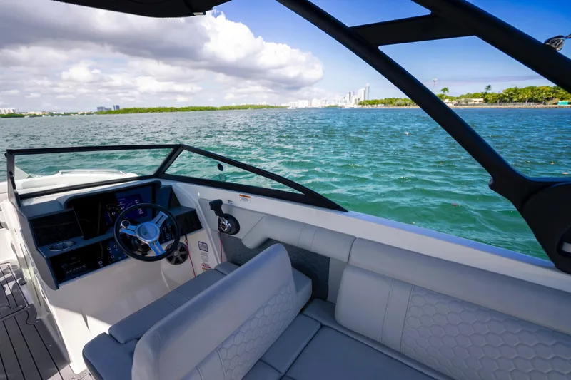 Slide: The Image of 2021 Yamaha Boats AR250 on open water, showcasing sleek interior and scenic ocean view. - 18