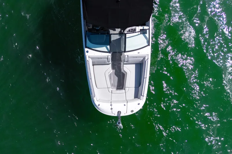 Slide: The Image of Overhead view of 2021 Yamaha AR250 boat on green water. - 2