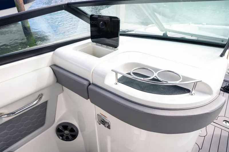 Slide: The Image of 2021 Yamaha AR250 boat interior with cup holders and storage compartment. - 22
