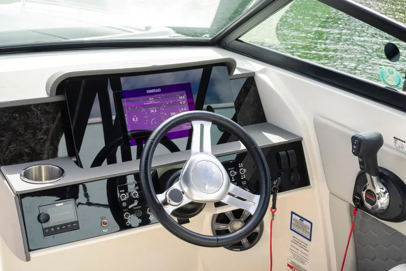 Slide: The Image of 2021 Yamaha AR250 boat dashboard with steering wheel and control panel. - 23