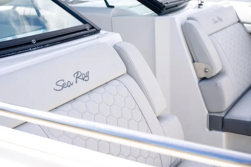 Slide: The Image of Luxurious white boat seats with "Sea Ray" logo, featuring hexagonal stitching design. - 24
