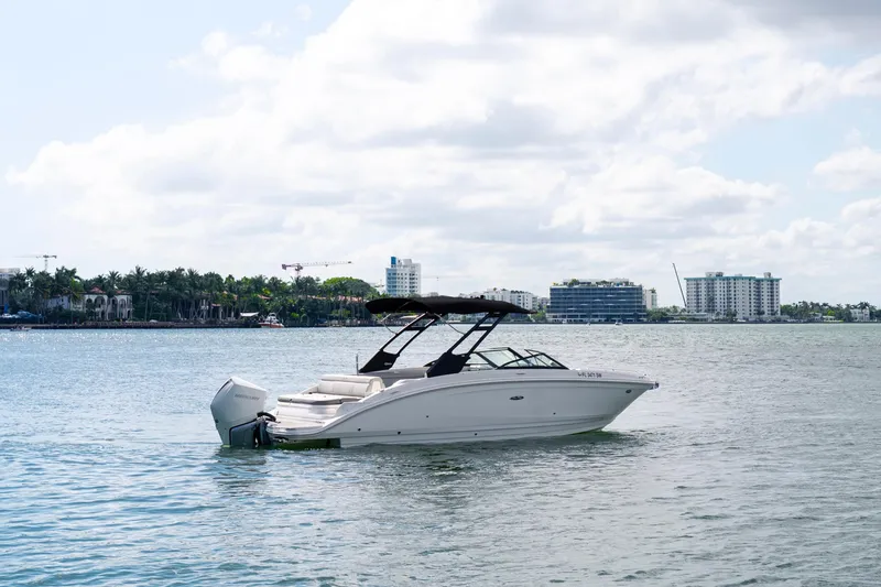 Slide: The Image of 2021 Yamaha Boats AR250 on calm water with cityscape background. - 3