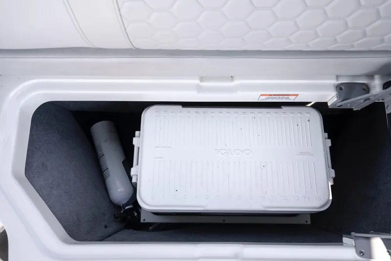 Slide: The Image of Storage compartment in 2021 Yamaha AR250 boat with Igloo cooler and fire extinguisher. - 31