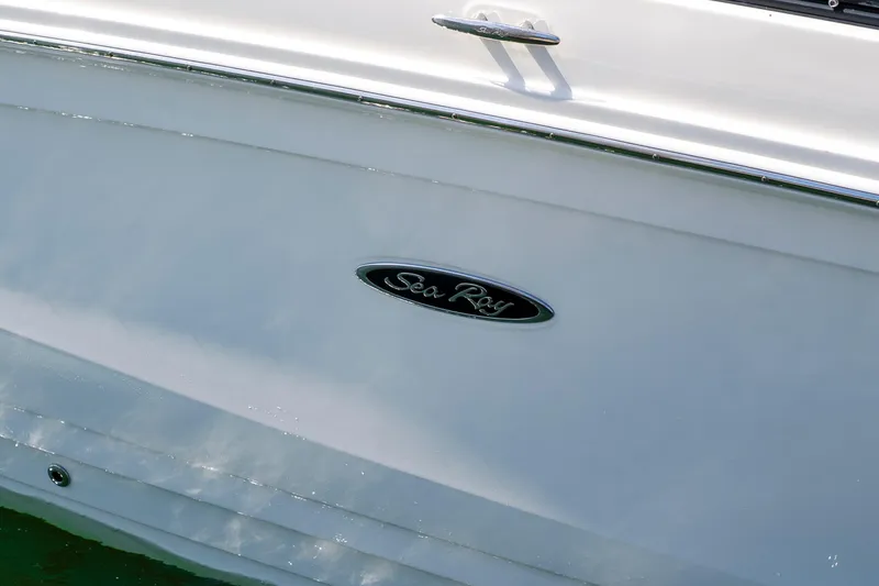 Slide: The Image of White boat with "Sea Ray" logo, reflecting sunlight on water. - 6