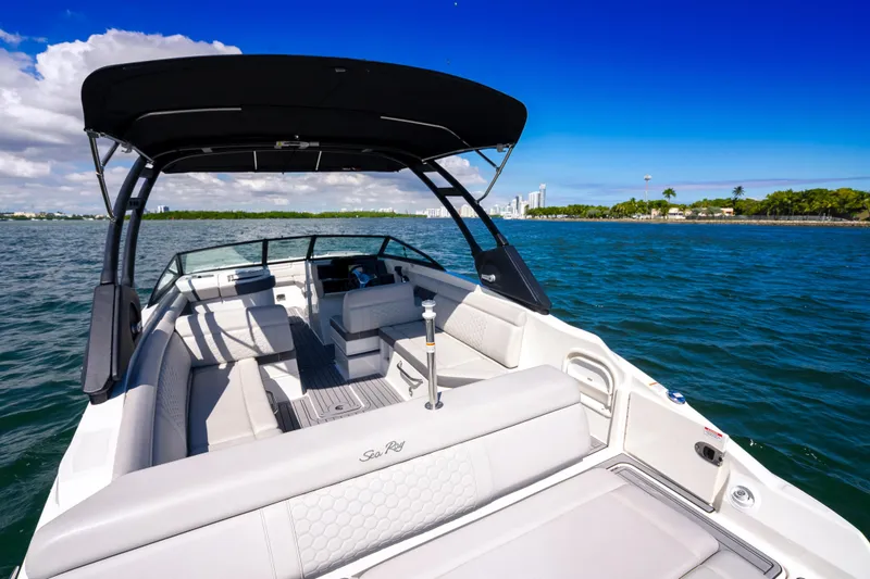 Slide: The Image of 2021 Yamaha Boats AR250 on water, featuring spacious seating and sleek design under clear blue sky. - 7