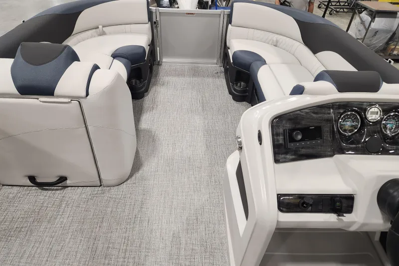 Slide: The Image of 2026 Avalon LSZ 2385 Entertainer boat interior with plush seating and modern dashboard. - 12