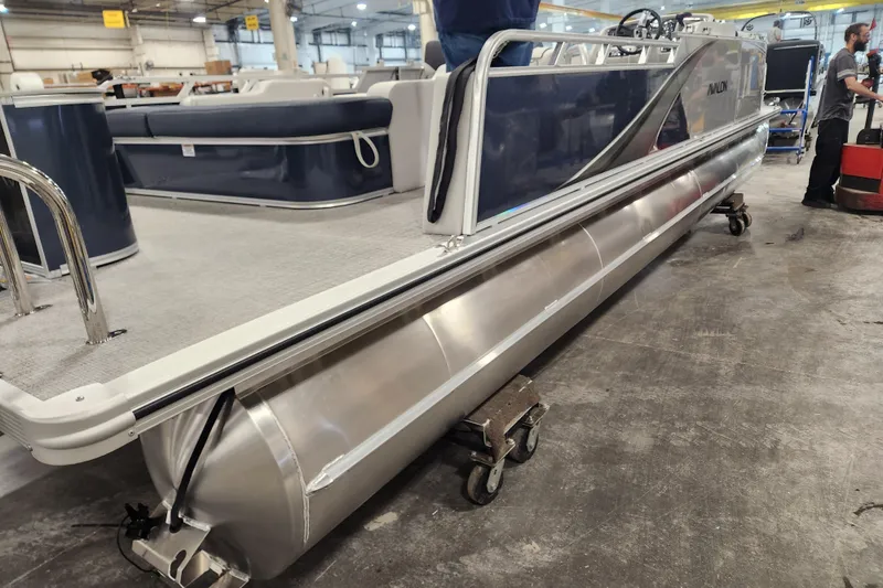 Slide: The Image of 2026 Avalon LSZ 2385 Entertainer pontoon boat with patio pad in a workshop setting. - 15