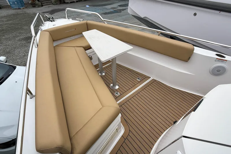 Slide: The Image of 2020 Axopar 28 Cabin boat with wet bar, featuring tan seating and sleek deck design. - 11