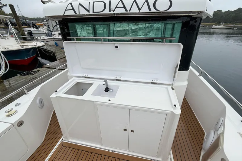 Slide: The Image of 2020 Axopar 28 Cabin with wet bar, docked, featuring sleek design and modern amenities. - 6