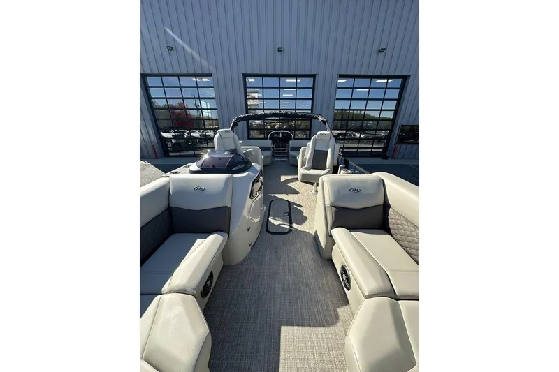 Slide: The Image of 2026 Manitou 23 Encore RF pontoon boat interior with luxurious seating and modern design. - 11