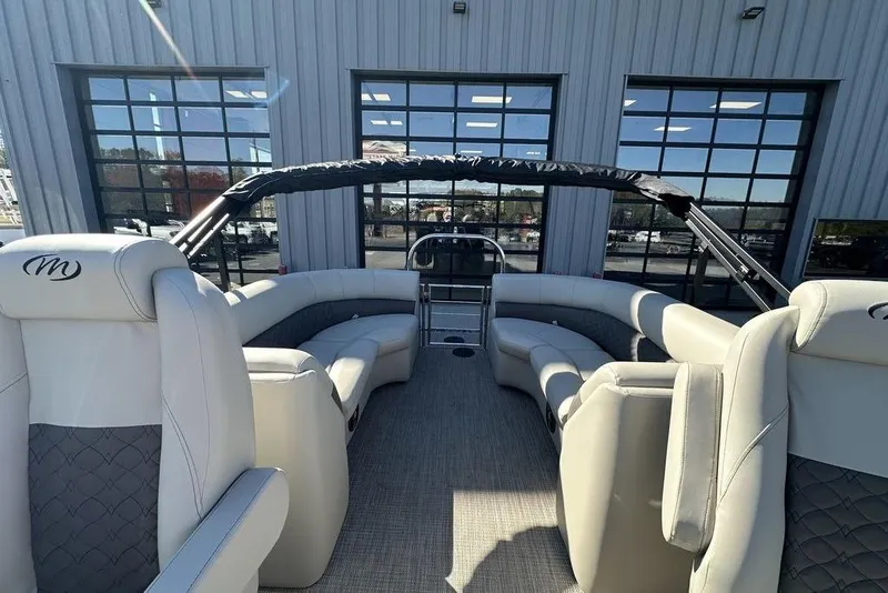 Slide: The Image of 2026 Manitou 23 Encore RF pontoon boat interior with luxurious seating and modern design. - 12