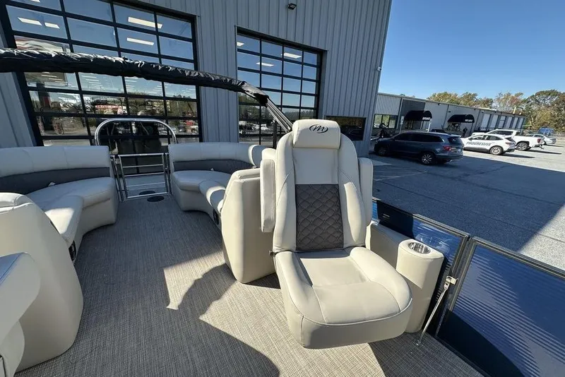 Slide: The Image of 2026 Manitou 23 Encore RF pontoon boat interior with luxurious seating and modern design. - 14