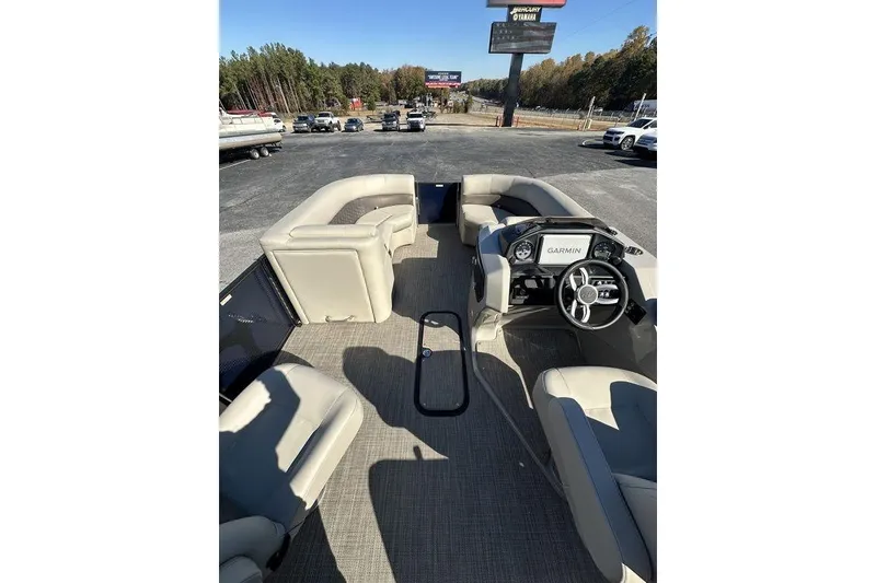 Slide: The Image of 2026 Manitou 23 Encore RF pontoon boat interior with seating and Garmin navigation system. - 15