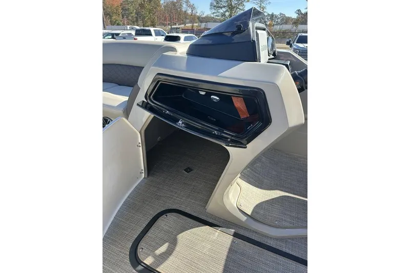 Slide: The Image of 2026 Manitou 23 Encore RF boat interior with open storage compartment. - 17
