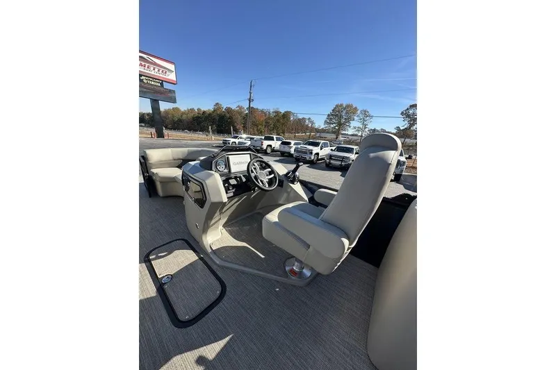 Slide: The Image of 2026 Manitou 23 Encore RF boat interior with steering console and seating. - 18