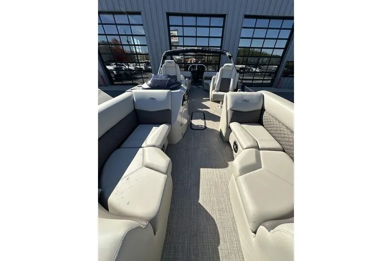 Slide: The Image of 2026 Manitou 23 Encore RF pontoon boat interior with luxurious seating and modern design. - 3