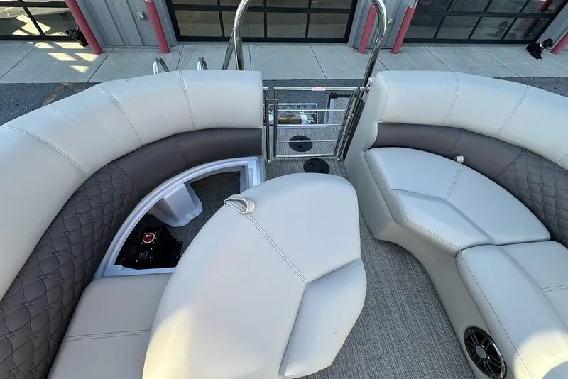 Slide: The Image of 2026 Manitou 23 Encore RF boat interior with luxurious seating and modern design. - 5