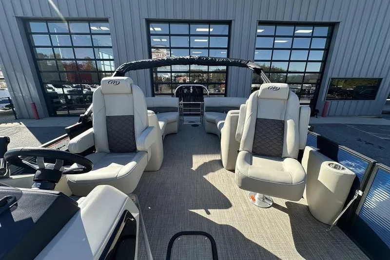 Slide: The Image of 2026 Manitou 23 Encore RF pontoon boat interior with luxurious seating and modern design. - 6