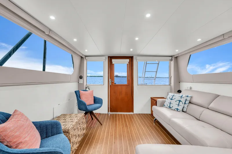 Slide: The Image of Interior of 1978 Hatteras 42 Convertible yacht with modern seating and ocean view. - 10