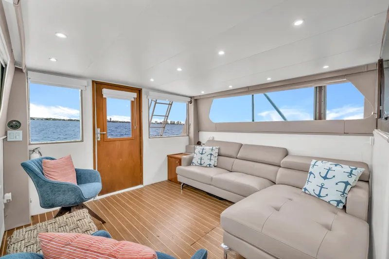 Slide: The Image of Interior of 1978 Hatteras 42 Convertible yacht with modern seating and ocean view. - 11