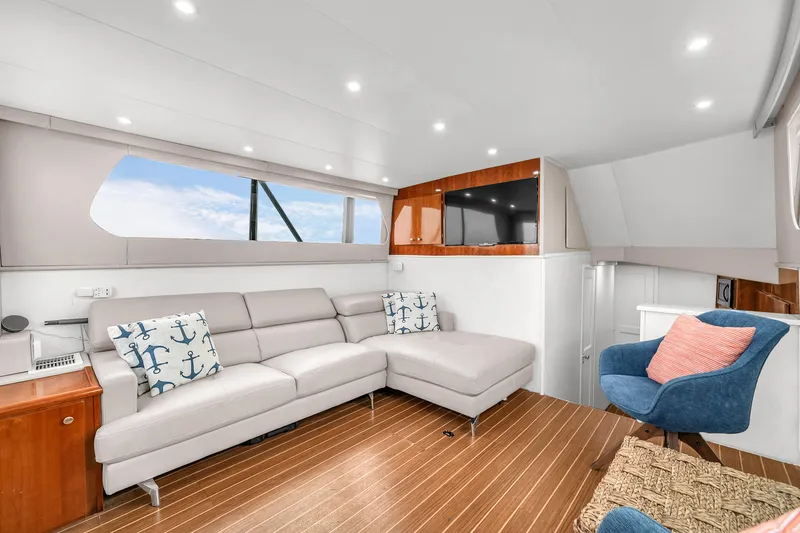 Slide: The Image of Luxurious interior of 1978 Hatteras 42 Convertible yacht with modern seating and decor. - 12