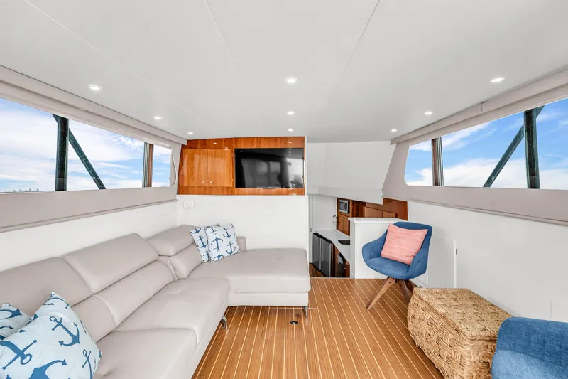 Slide: The Image of Interior of 1978 Hatteras 42 Convertible yacht with modern furnishings and wood flooring. - 13