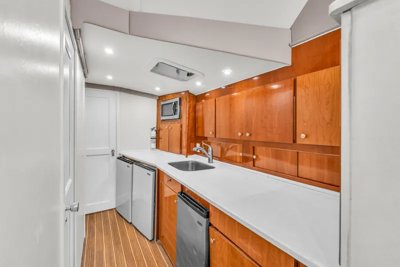 Slide: The Image of 1978 Hatteras 42 Convertible yacht kitchen with wood cabinets and modern appliances. - 16