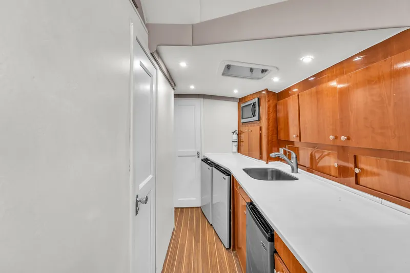 Slide: The Image of 1978 Hatteras 42 Convertible yacht kitchen with modern appliances and wooden cabinetry. - 17