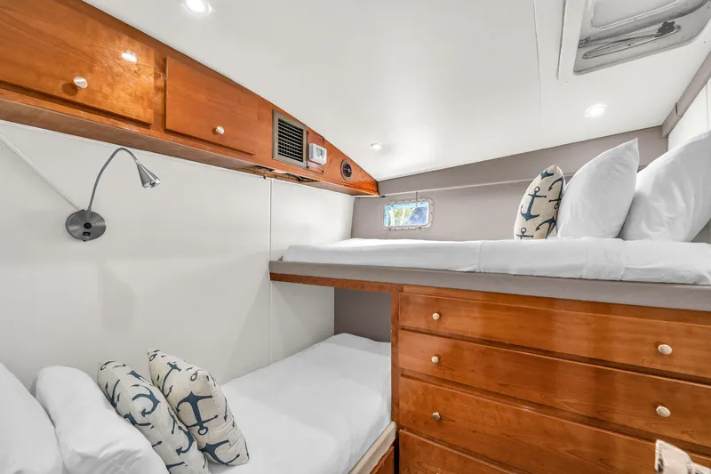 Slide: The Image of Cozy cabin interior of 1978 Hatteras 42 Convertible with wooden bunk beds and nautical decor. - 22