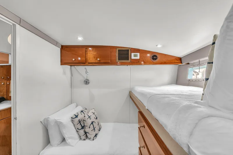 Slide: The Image of Cozy cabin interior of 1978 Hatteras 42 Convertible yacht with bunk beds and nautical decor. - 23