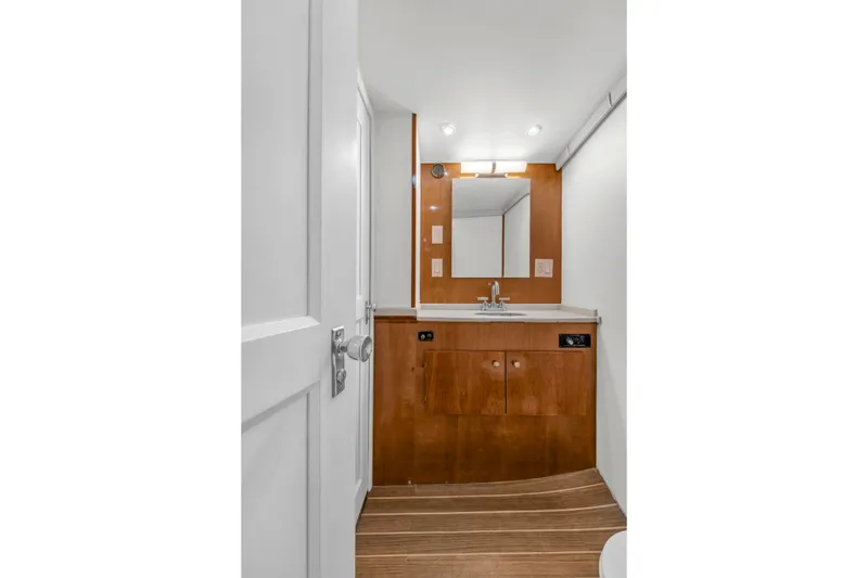 Slide: The Image of 1978 Hatteras 42 Convertible yacht bathroom with wooden cabinetry and modern fixtures. - 24
