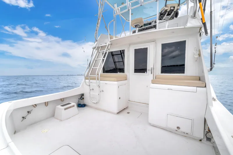 Slide: The Image of 1978 Hatteras 42 Convertible yacht deck with ocean view and clear sky. - 26