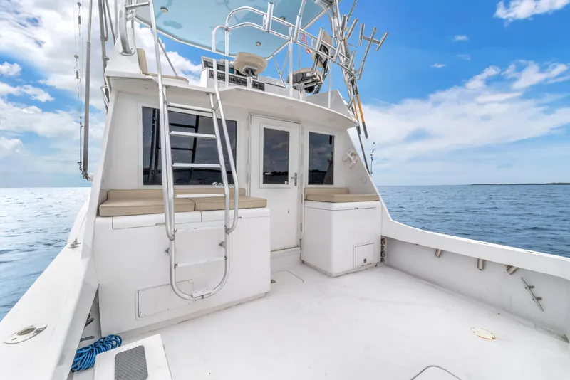 Slide: The Image of 1978 Hatteras 42 Convertible boat deck with ocean view and clear sky. - 28