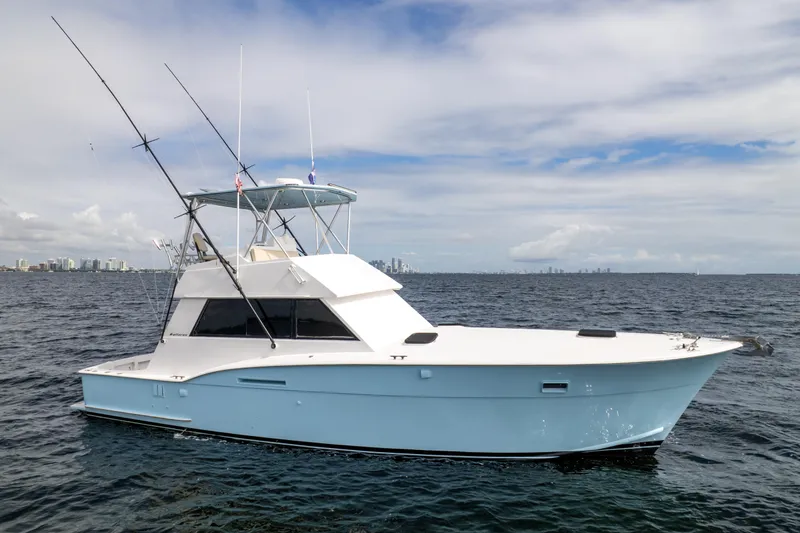 Slide: The Image of 1978 Hatteras 42 Convertible yacht on open water under a cloudy sky. - 3