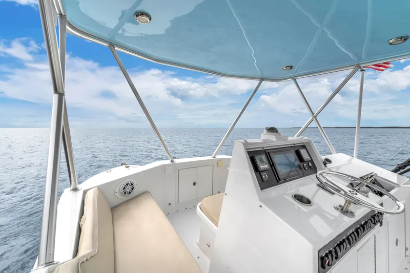 Slide: The Image of 1978 Hatteras 42 Convertible boat helm with ocean view and clear blue sky. - 31