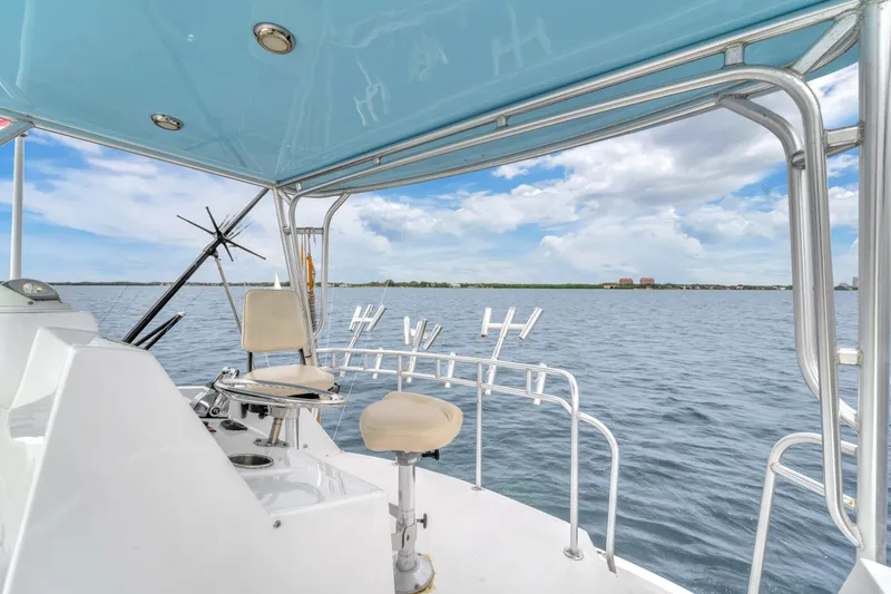 Slide: The Image of 1978 Hatteras 42 Convertible boat deck with ocean view and fishing rod holders. - 33