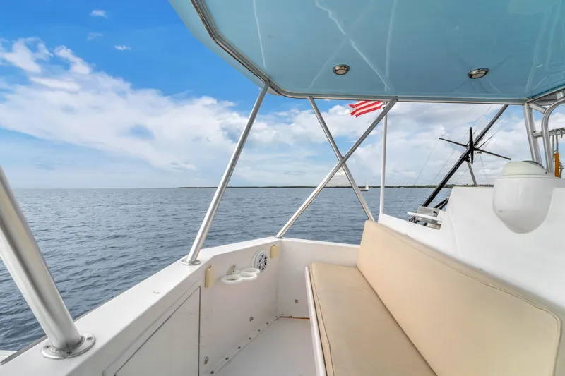 Slide: The Image of 1978 Hatteras 42 Convertible boat interior with ocean view and American flag. - 34