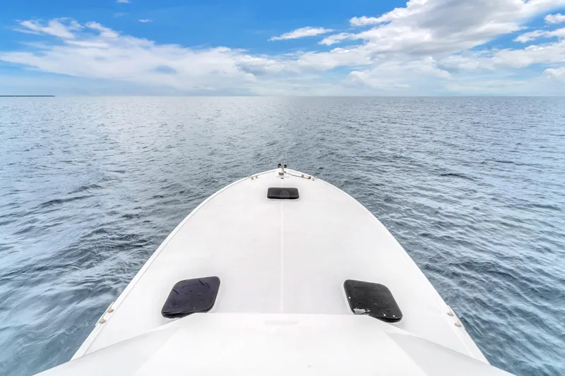 Slide: The Image of Bow view of 1978 Hatteras 42 Convertible yacht on open sea under blue sky. - 37