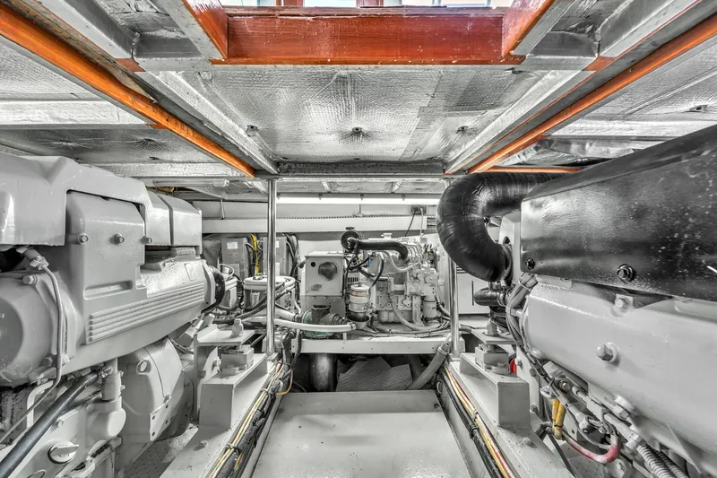 Slide: The Image of Engine room of 1978 Hatteras 42 Convertible yacht, showcasing dual engines and mechanical components. - 38
