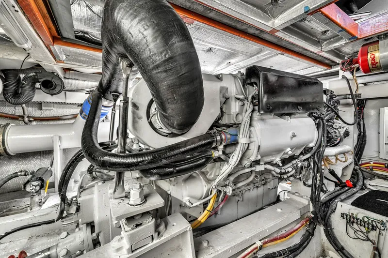 Slide: The Image of Engine room of a 1978 Hatteras 42 Convertible yacht, showcasing detailed machinery. - 39